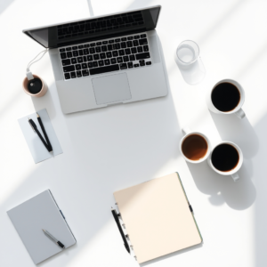 Free AI photo: Minimal white desk workspace with laptop, notebook, coffee cup and soft shadows, top view, clean composition, realistic stock photography, lots of copy space.