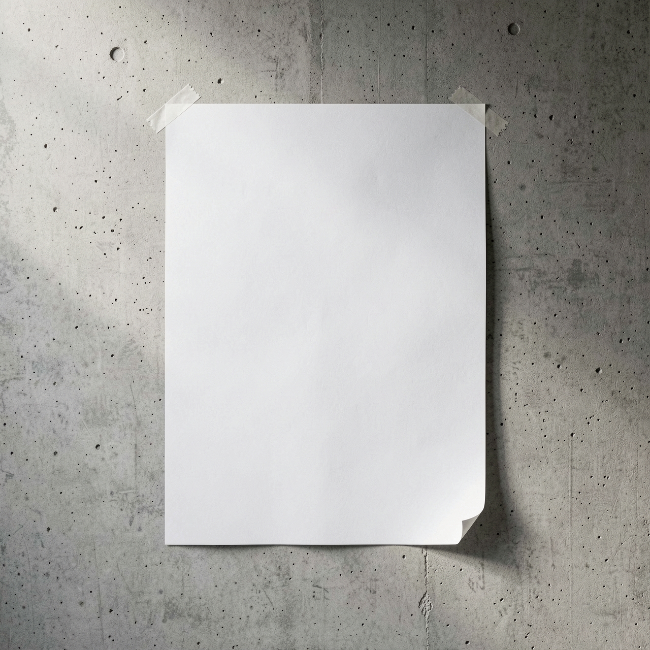 A blank white poster is taped to a raw concrete wall with soft daylight shining from the left.